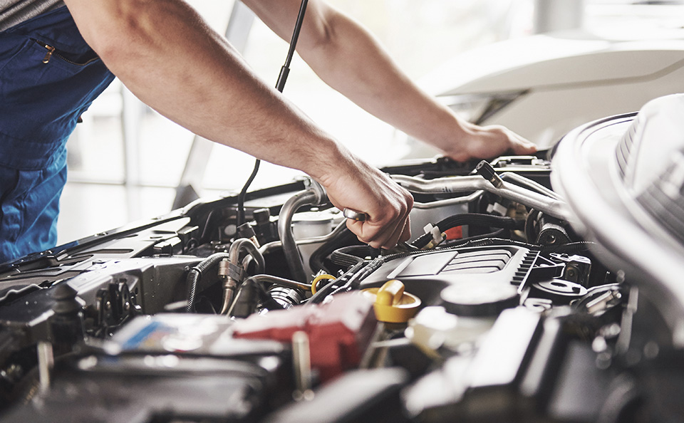 A Certified mechanic checks out the GMC SUV engine