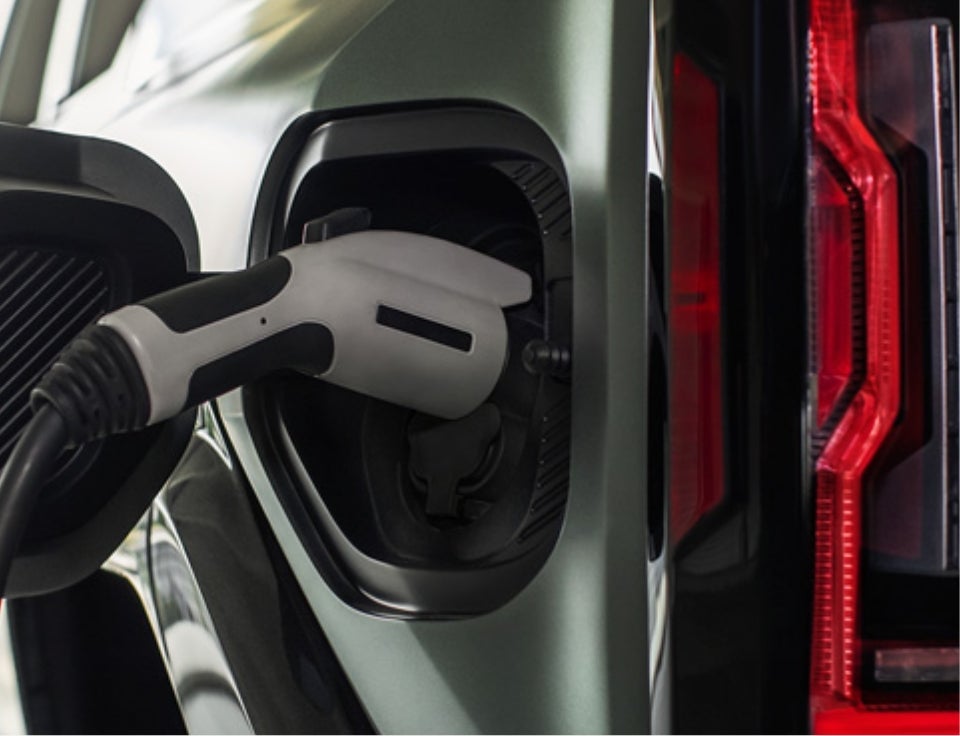 Close up of charging port with charger plugged in on a GMC Hummer EV SUV - Runde Buick GMC of Platteville in Platteville WI